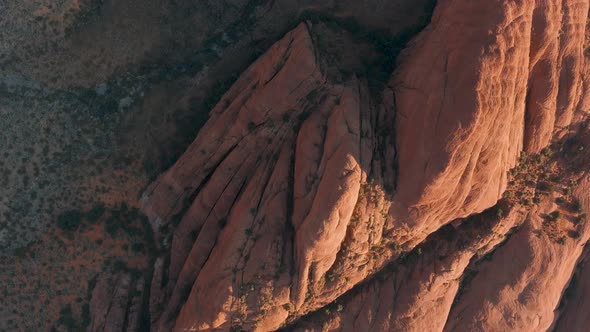 Overhead aerial of the sun setting on rocks in Snow Canyon State Park.