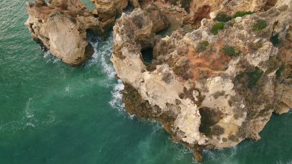 Aerial. Flying Along the Shore of Beach Rocks Arrifes, Albufeira. Portugal