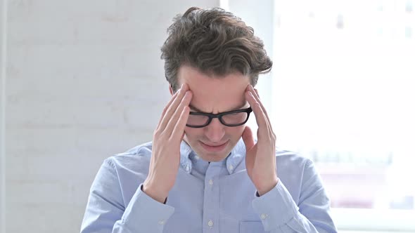Portrait of Stressed Young Man Having Headache