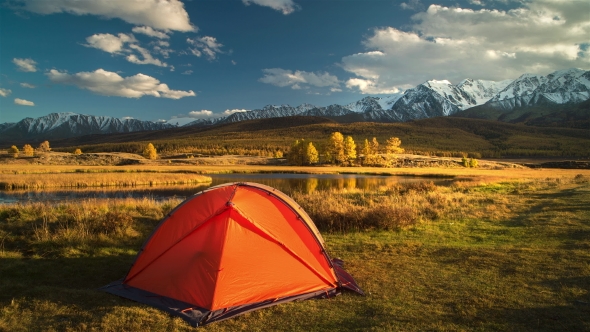 Tourist Tent in Camp Among Alpine Meadows in the Mountains at Sunset.