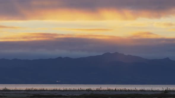 Mountain Silhouette, River and Land, Slow Zooming Out, Sunset, Long shot