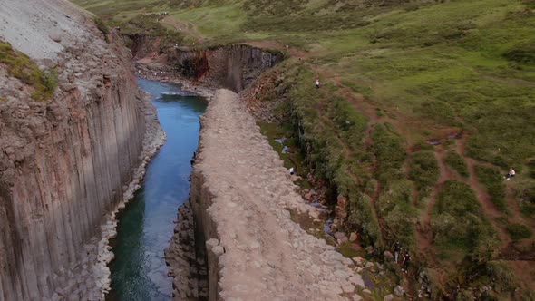 Studlagil Canyon and View of Grassy Horizon and Basalt Pillars with River