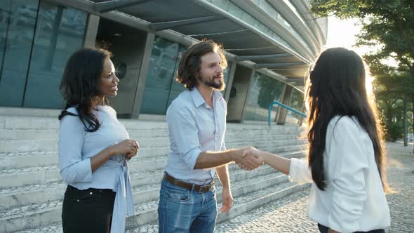 Successful Young Businessman Shaking Hands with Female Partner