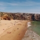Happy People Rest on a Beautiful Sandy Beach in Portugal, Praia Do Beliche, Sagres, Aerial View - VideoHive Item for Sale
