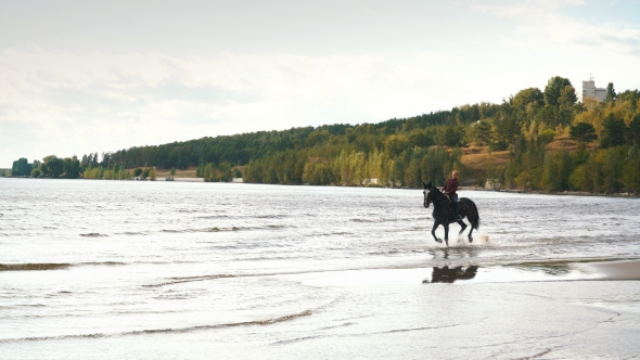 Young Pretty Girl Riding Horse in River Water