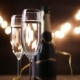 Two Flutes with Sparkling Wine Over Holiday Bokeh Blinking Background - VideoHive Item for Sale