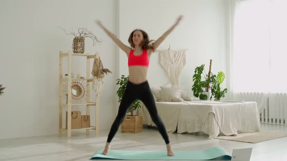 Woman Doing Jumping Jacks Exercise at Home