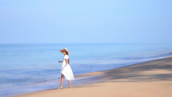 Asian woman enjoy around beautiful beach sea ocean