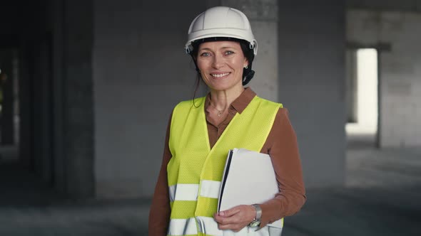 Portrait of female caucasian engineer holding document