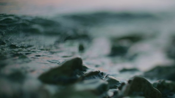 Blue Water Surface Waving Over Stone