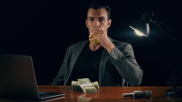 Handsome man plays with a stack of cash