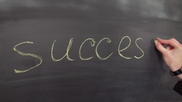 Hand Writes the Word Success