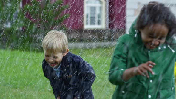 Happy Children Running in Heavy Rain