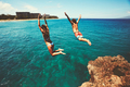 Friends cliff jumping into the ocean - PhotoDune Item for Sale