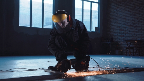 Workman Angle Grinding in Protective Clothing