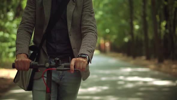 Driving Ecology Transportation. Man Ride Electric Scooter Mobility. Drive Electric Scooter In City.