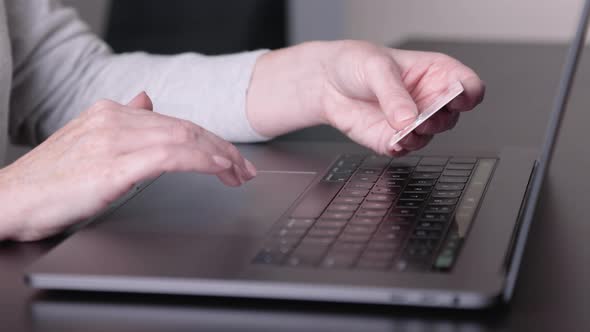 Female holding credit card, paying purchases online, Close-up view