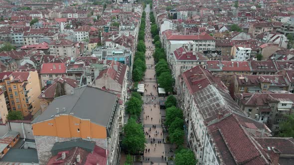 Tilt up of drone shot over Vitosha street, main walking street in Sofia, Bulgaria. Revealing Nationa