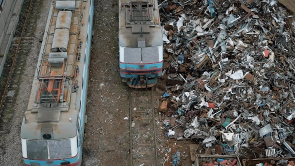 A View From Above of Old and Broken Trams, Next To Them Is a Non-ferrous Metal 