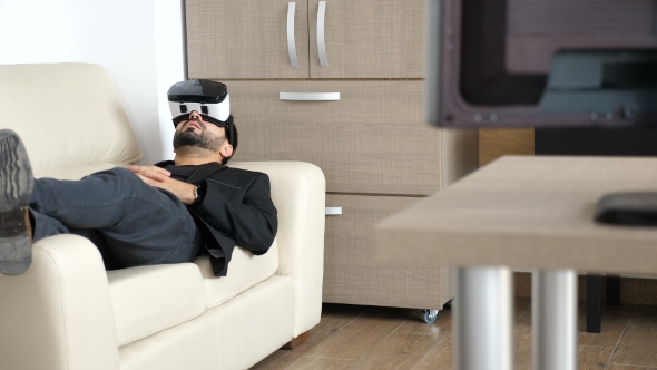 Businessman Is Taking a Break in His Office Using the VR Headset Technology