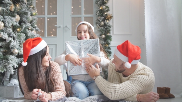 Cute Girl Gets Christmas Gift From Parents.