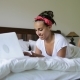 Young Woman Using Laptop Computer Typing Beautiful Girl Lying On Bed In Bedroom Morning - VideoHive Item for Sale