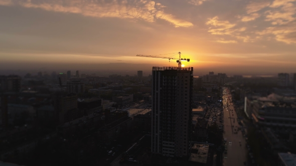 Aerial Bird View of Yellow Tower Building Crane Fly Around Construction Site Building Apartments