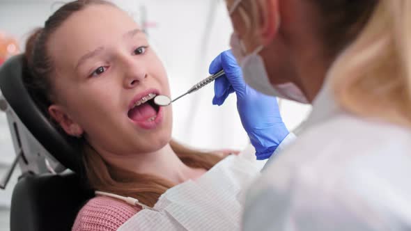 Dentist's Hand Using Dental Mirror During Checkup