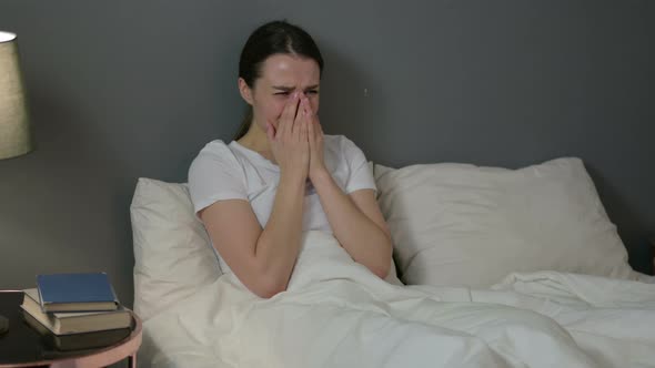 Upset Young Woman Crying in Bed 