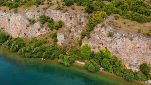 Aerial shot of Macedonia coast. Clif and beautiful water around Ohrid Lake in Southern Europe.