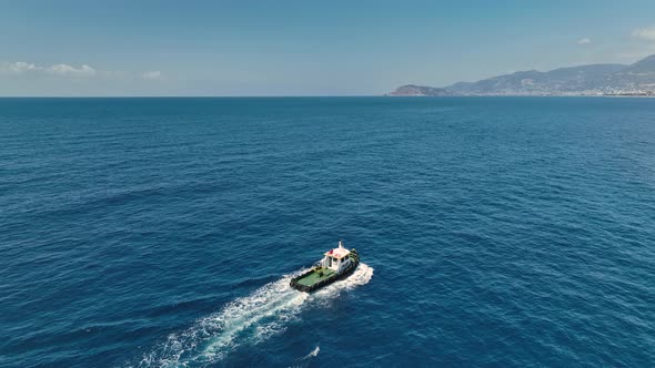 Tug boat sails in port aerial view 4 K Turkey Alanya