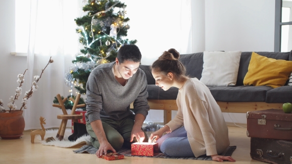 Romantic Couple Exchanging Christmas Gifts.