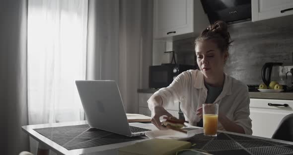 Young Woman Studying in Kitchen