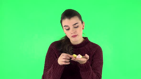 Woman with Pleasure Eating Sweet White Marshmallow and Is Disgusted. Green Screen