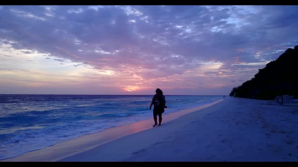 Female model enjoys life on luxury coastline beach trip by clear ocean with white sand background of