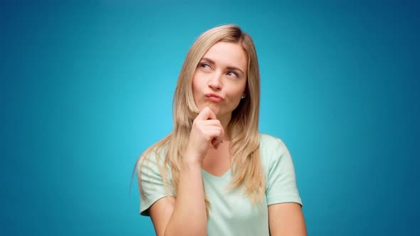 Blonde Woman Thinking Over Smart Idea Pondering Against Blue Background