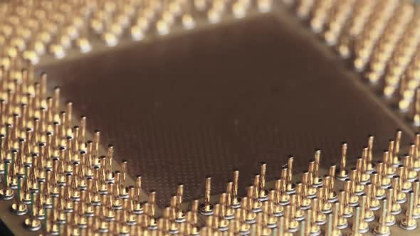 The Computer Processor CPU with Gold Plated Contacts Spins on Green Background