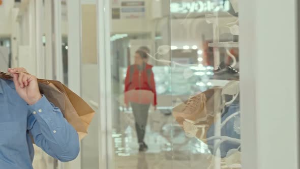 Sliding Shot of a Mature Couple Shopping at the Mall Together