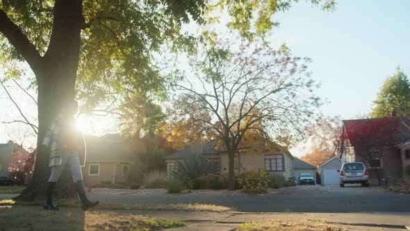 Camera Following Woman on Trip Enjoying Warm Autumn Day and Cinematic Foliage