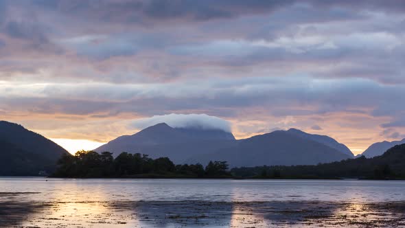 Time lapse of lake and clouds at sunset in the highlands in Scotland