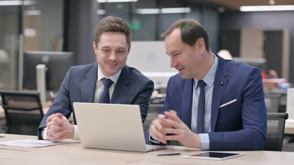 Businessman and Colleague Doing Video Call on Laptop