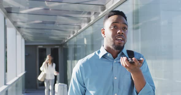 Video of african american man walking and using smartphone