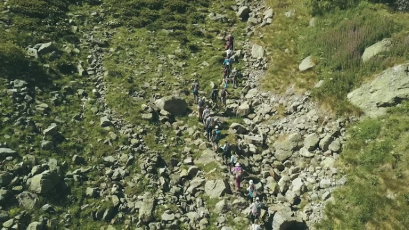 Hiking Group Walking on Rocky Trail in Mountain. Climbing a Mountain