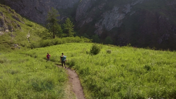 Two Tourists Go Along the Path Uphill. View From Above