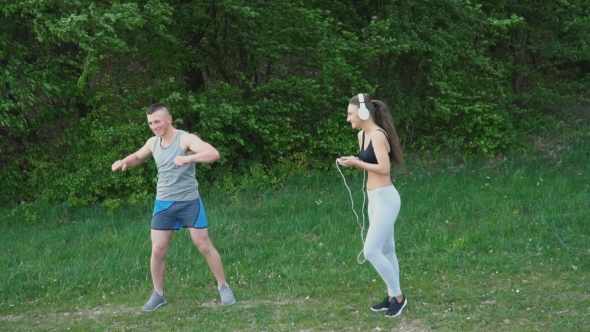 The Guy Does the Warm-up While the Girl Is Wearing Headphones