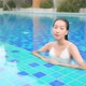 Young asian woman enjoy around outdoor swimming pool for leisure - VideoHive Item for Sale