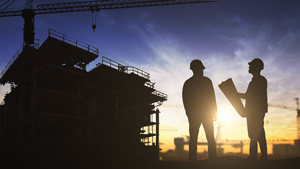 Construction Worker Looking At Blueprints alt