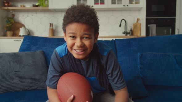 Excited Cute Black Boy Watching American Football on Tv Celebrating Touchdown