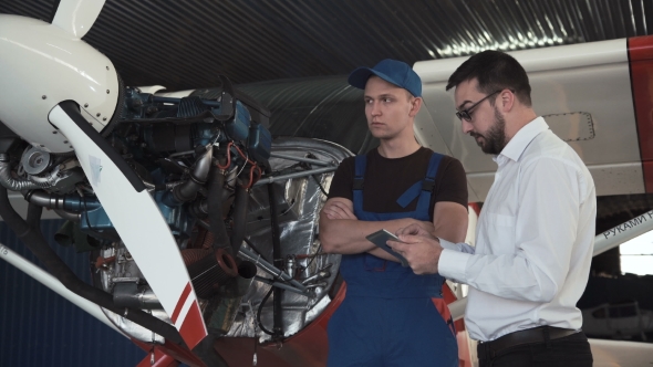 Mechanic and Flight Engineer Having a Discussion