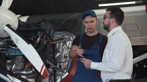 Mechanic Talking To Draftsman